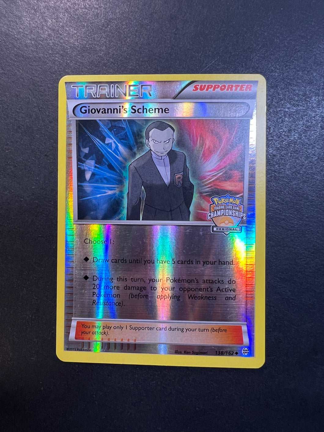 Giovannis Scheme - 138/162 Reverse Holo Trainer - League Promo Giovannis Scheme - 138/162 Reverse Holo Trainer - League Promo